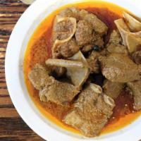 Curry Goat · Goat meat cooked in variety of fine spices.