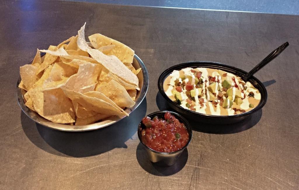 Loaded Queso · House queso, Angus beef, pico, hatch green chiles, avocado, sour cream and side of chips and salsa.