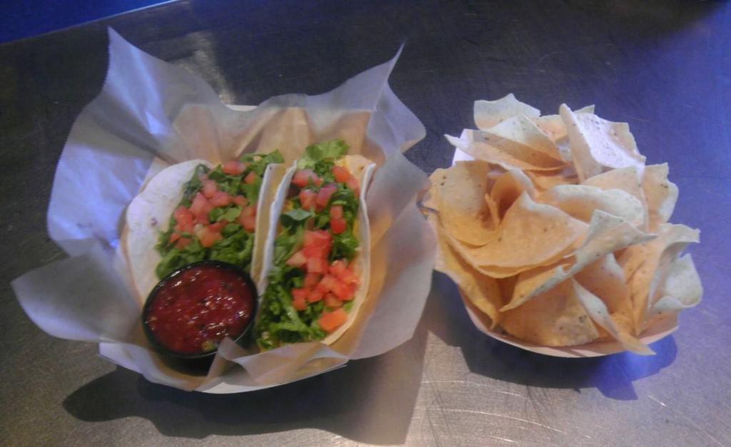 The Classic Basket Taco · 2 tacos, chopped leaf lettuce, diced tomato and cheddar cheese. Served with choice of tortilla and sides.