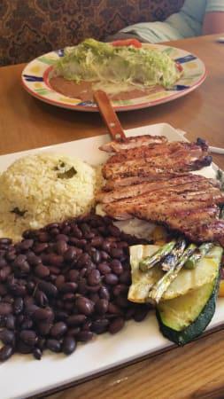 MP Jerk Chicken · Grilled seasoned jerk chicken breast over a bed of pineapple and sour cream sauce. Served with white rice, black beans and grilled vegetables.