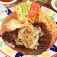 MP Beef Steak a la Tampiquena · 8 oz. ribeye steak topped with grilled onions. Served with Mexican rice, refried beans and g...