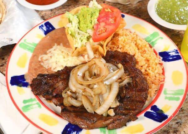 MP Beef Steak a la Tampiquena · 8 oz. ribeye steak topped with grilled onions. Served with Mexican rice, refried beans and guacamole salad. Choice of flour or corn tortillas.