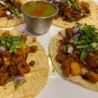 Tacos Campechanos · 3 tacos filled with chicken and chorizo, topped with onions and cilantro. Served with rice a...