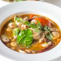 Tom Yum Soup · Hot and sour soup with lemongrass, galangal, kaffir lime leaves, mushrooms, tomatoes, scalli...