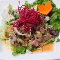 Barbeque Pork Salad · Grilled marinated pork, cucumber, tomatoes, roasted chili and Thai herbs in lime dressing.