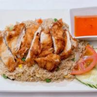 Fried Chicken Over Fried Rice · Battered chicken breast, eggs, onions, scallions and tomatoes with sweet and sour dipping sa...