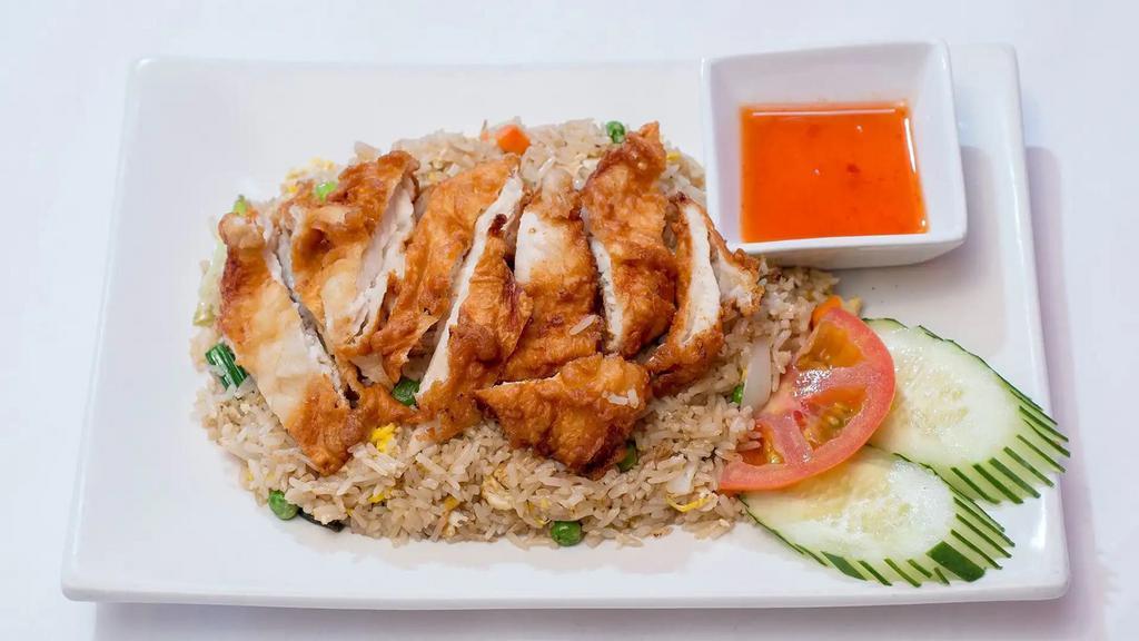 Fried Chicken Over Fried Rice · Battered chicken breast, eggs, onions, scallions and tomatoes with sweet and sour dipping sauce.