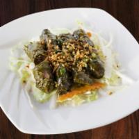 6. Grilled Beef Wraps · Seasoned grilled beef wrapped in tender grape leaves. Served with lettuce, daikon, pickled c...