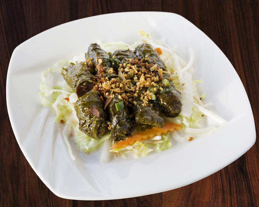 6. Grilled Beef Wraps · Seasoned grilled beef wrapped in tender grape leaves. Served with lettuce, daikon, pickled carrot, crushed peanut, and onions.