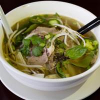 11. Beef Noodle Soup Pho · Beef broth served with rice noodles and a side of fresh bean sprouts, Vietnamese basil, jala...