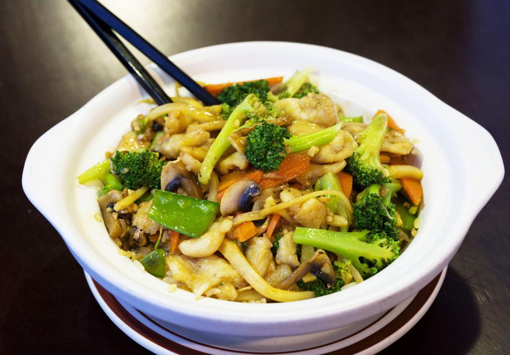 25. Clay Pot · Stir fried rice with snow peas, broccoli, and carrots.