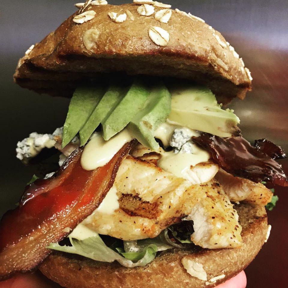Chicken Fit Club Sandwich · Grilled chicken breast with crisp applewood smoked bacon, sliced avocado, crumbled Blue cheese, Dijon mustard-mayo, spring mix lettuce and tomato. Served on a toasted honey wheat bun.