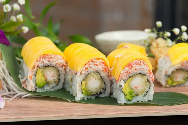 R26. Golden Shrimp Roll · Inside: Shrimp tempura and avocado. Outside: Kani salad and mango. Sauce: Mango sauce.