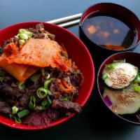 Bulgogi Bowl · Marinated Korean beef over rice. Includes salad with Japanese ginger dressing and miso soup. 