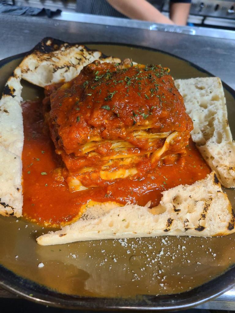 Lasagna with Meat Sauce · Served with toasted ciabatta bread, wild mushrooms, red wine, ground beef, tomato and herbs