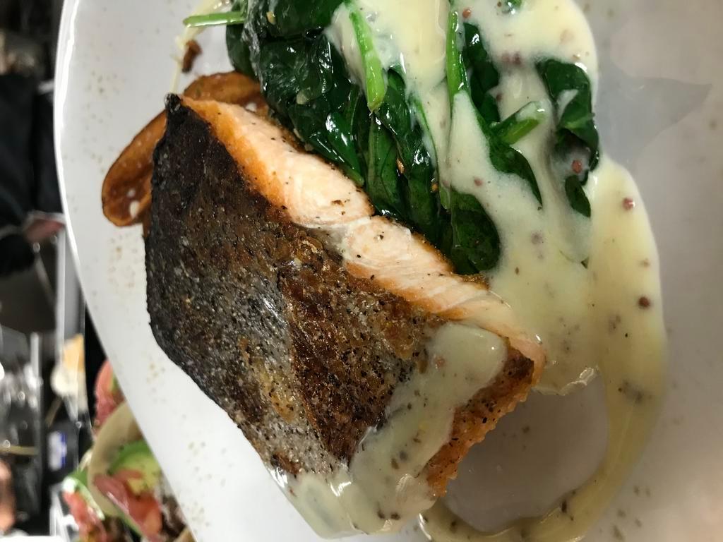 Pan Seared Salmon  · 6oz Scottish salmon fillet served with crispy herbed fingerling potatoes, garlic spinach and a lemon beurre blanc