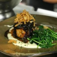 Grilled Pork Chop · Served with roasted cauliflower puree, Garlic spinach, port wine reduction, and crispy onions