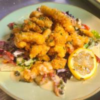 Chef’s Calamari  · Dusted in seasoned flour and fried. Served with sun dried tomato butter sauce and fried capers