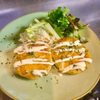 Crab & Whitefish Cakes  · Seared crab cakes served over a green apple and cabbage slaw 