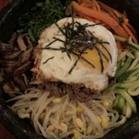 Dol Sot · Hot stone bowl bibimbap. Assorted vegetables and fried eggs over rice in a hot stone bowl. S...