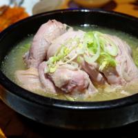 Sam Gye Tang · Ginseng chicken soup. Chicken stuffed with ginseng, sticky rice, jujube and garlic. Served w...