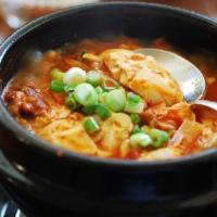 Sun Du Bu JjiGae · Spicy soft tofu stew with zucchini, onions and mushrooms. Spicy.