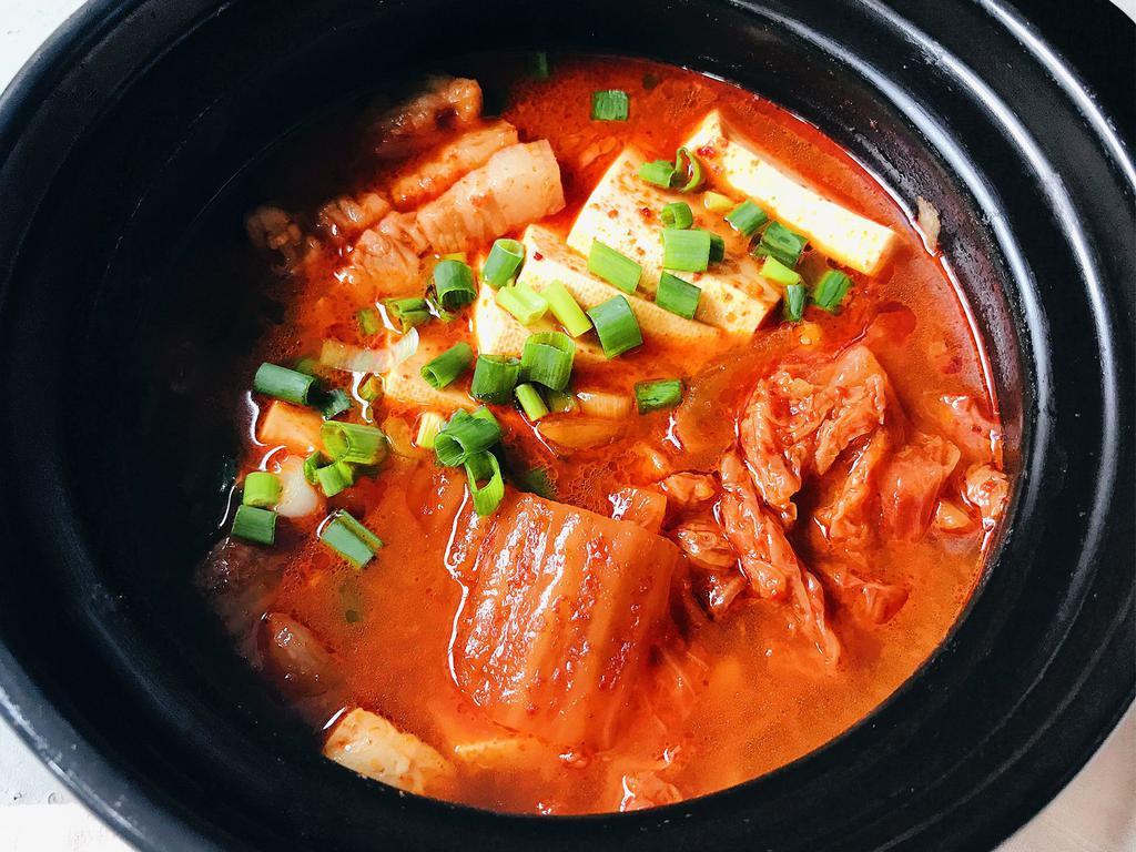 Kimchi JjiGae · Kimchi and pork stew with tofu and vegetables. Spicy.