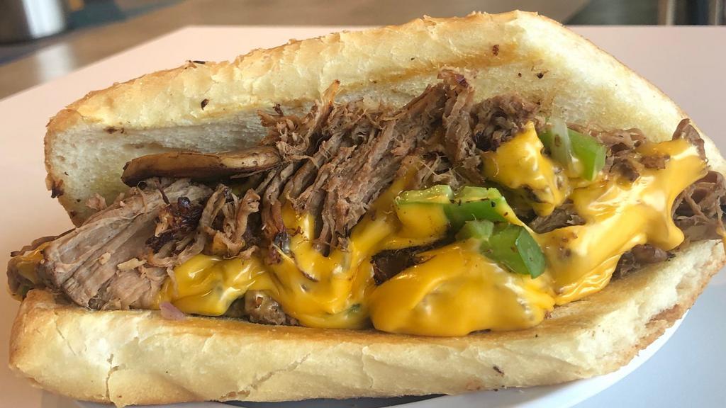 Brisket Cheesesteak · Tender beef brisket served on a traditional Philly style roll with grilled peppers, mushrooms, onions, and melted cheese.