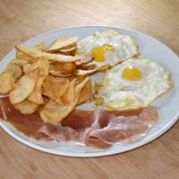 Huevos Fritos, Jamon Serrano y Patatas Fritas · Incluye 1 cafe con leche. Fried eggs with Serrano ham and fried natural potato chips include...