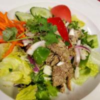Tiger Tear Salad · Grilled beef mixed with lime juice, red onion, scallion, cilantro and fresh Thai spices on a...
