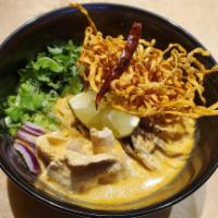 Red Curry Ramen · Thai red curry soup with ramen noodle and topped with crispy noodle, scallion, and cilantro.