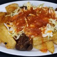 Yuca Frita · Served with pork meat in pieces with some tomato sauce.