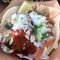 Spicy Fried Chicken Taco · Tossed in a traditional hot sauce with jalapeno ranch, slaw and cilantro.