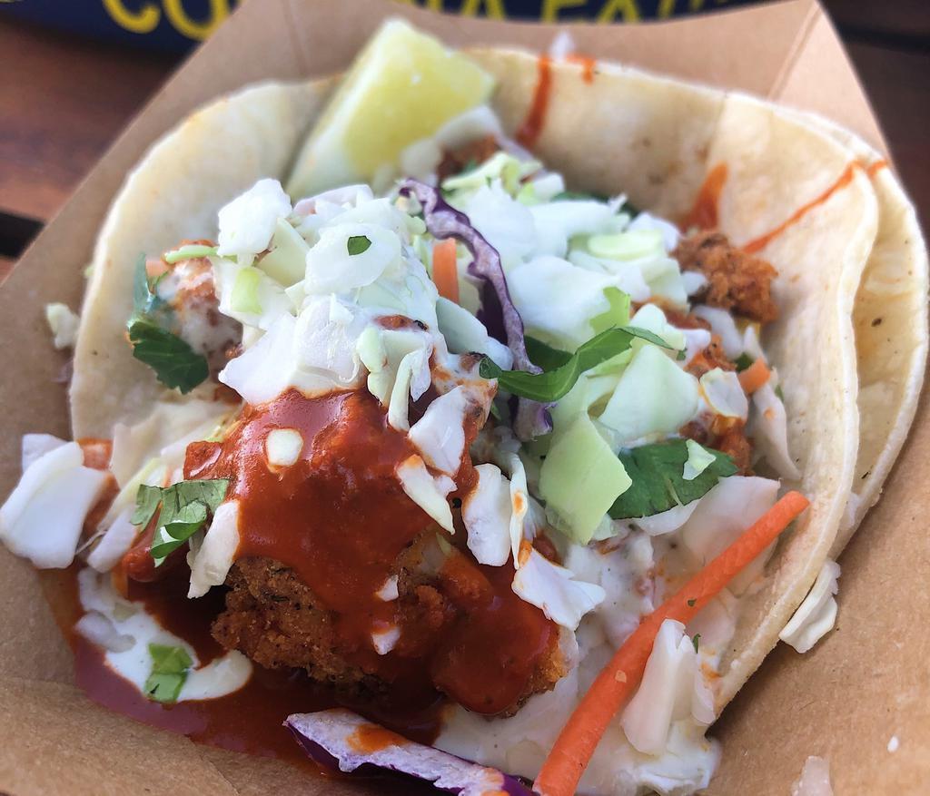 Spicy Fried Chicken Taco · Tossed in a traditional hot sauce with jalapeno ranch, slaw and cilantro.