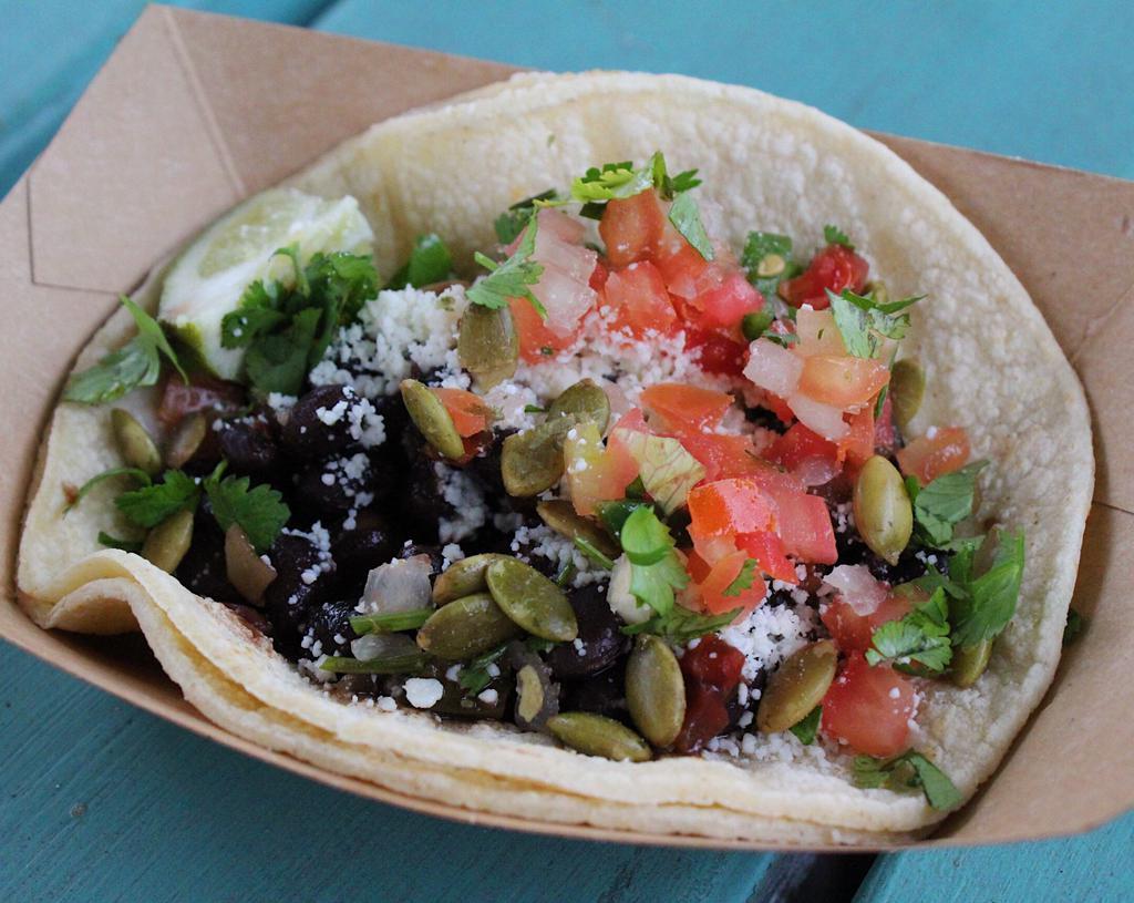 #12. Black Bean Taco · Chipotle black beans with pico de gallo, Cotija cheese, cilantro and toasted pumpkin seeds. Served on a corn tortilla. Vegetarian.