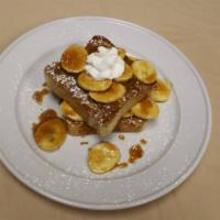 Caramelized Banana French Toasts · 2 Pieces Topped with whipped cream and powder sugar.  Maple syrup on the side
and a choice o...