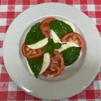 Caprese Salad · Fresh mozzarella, tomato, basil. Served with bread.