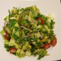10. Vostok Salad · Cucumbers, cherry tomatoes, onions, avocado, and greens, dressed with lemon juice and olive ...