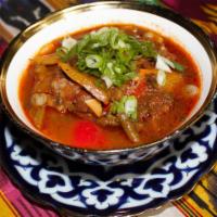 8. Chuchvara with Sauce · Traditional Uzbek: beef dumplings served with broth and vegetables topping.