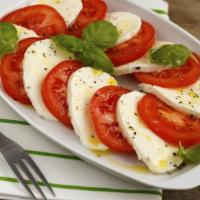 Tomato Caprese · Sliced fresh mozzarella, tomato, basil and olive oil drizzled with balsamic glaze.