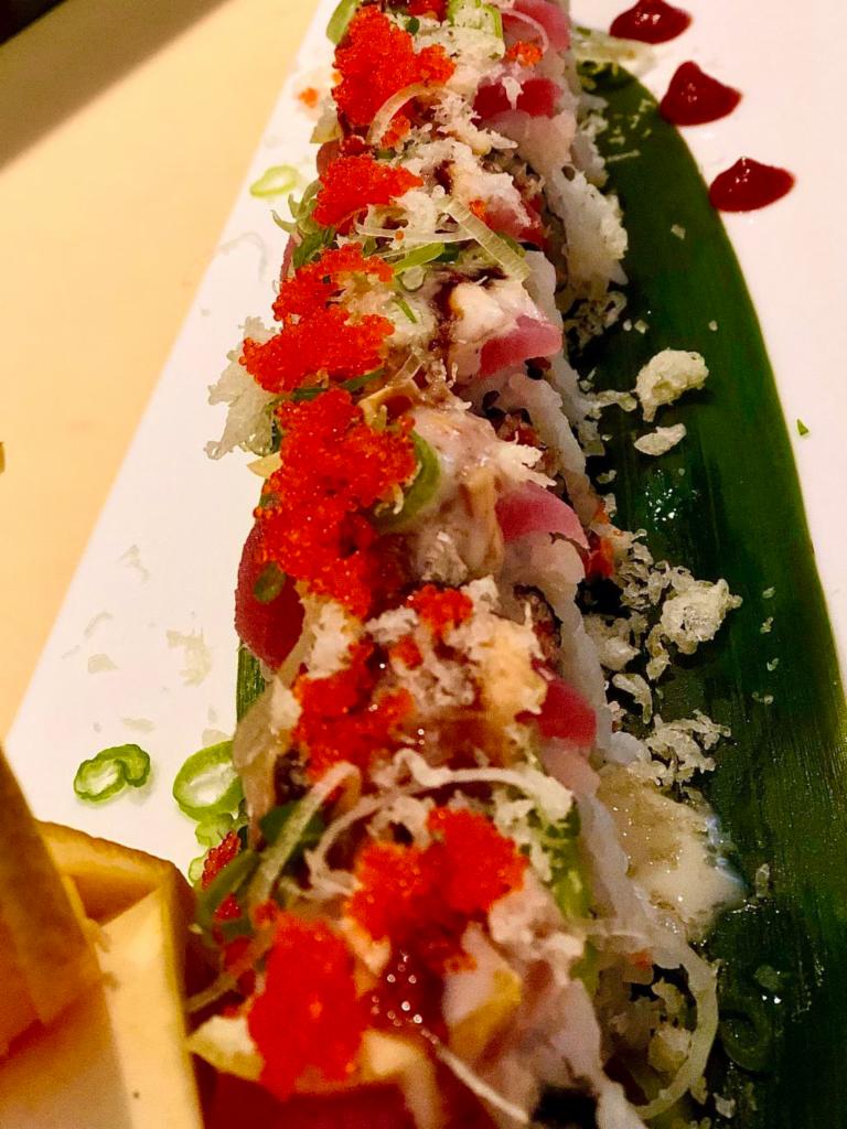S22. Pink Lady Roll · Spicy crunchy tuna topped with tuna sliced lemon, crunchy, scallion, fish eggs and dynamite sauce.