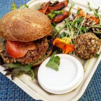 Bombay Bomb Burger (Vegan) · Served on whole wheat bun, house sauces, lettuce, tomato, sauteed onion,  with sweet potato ...