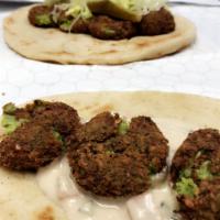 Falafel Pitawich · Fried Mashed Chick Peas Falafel, lettuce, arab pickles, tomatoes, and Mo's sauce. 
Served in...