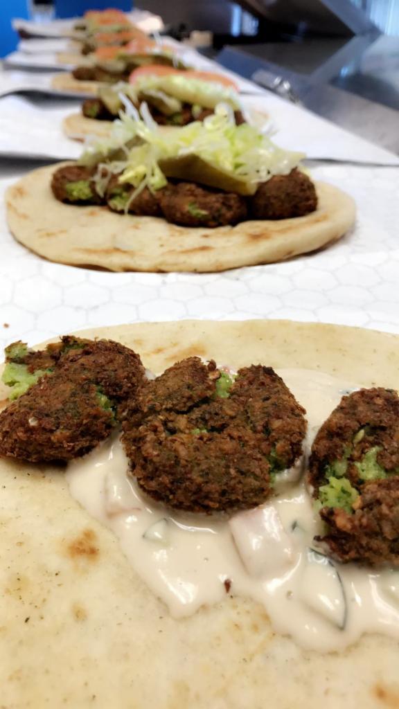Falafel Pitawich · Fried Mashed Chick Peas Falafel, lettuce, arab pickles, tomatoes, and Mo's sauce. 
Served in Pita