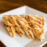 Quesadilla · Stuffed with Chihuahua cheese, black beans, roasted tomato corn salsa and chipotle-lime crem...
