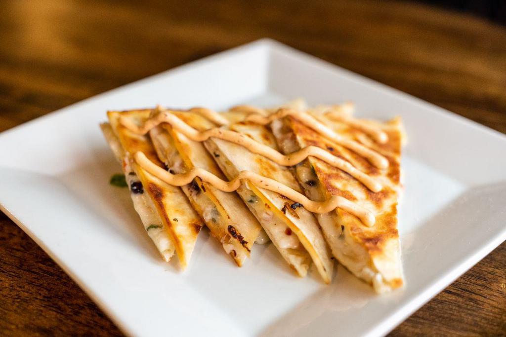 Quesadilla · Stuffed with Chihuahua cheese, black beans, roasted tomato corn salsa and chipotle-lime crema. Add chicken or chorizo for an extra charge.