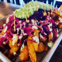Cajun Shrimp Fries  · Our famous fries, tossed in cajun, topped with cabbage slaw, 1/2 of an avocado and drizzled ...