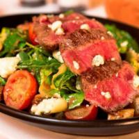 Steak Salad · marinated and grilled flat iron over romaine, dried cranberries, garlic croutons, diced toma...