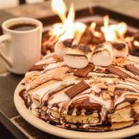 S’Mores Pancakes · Crushed graham crackers & chocolate chips sprinkled in a short stack of pancakes and topped ...