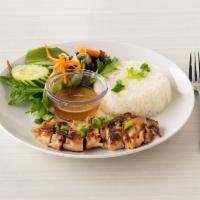 C2. Lemongrass Chicken Rice · Marinated chicken thigh served with steamed rice, vegetables and a side of fish sauce.